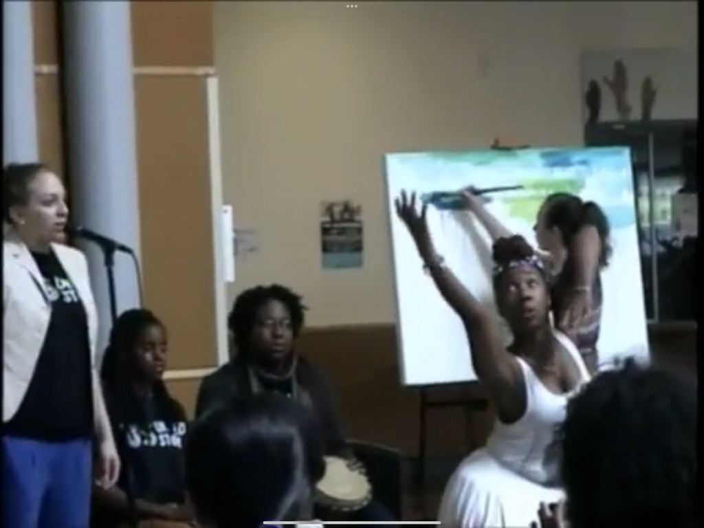 Screen capture of spoken word performer, interpretive dancer, and painter